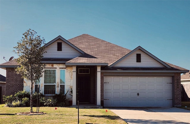 view of front facade featuring a garage and a front lawn