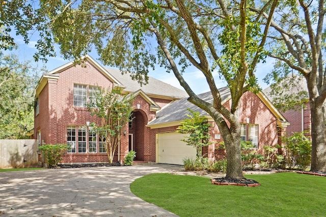 view of front facade featuring a front yard and a garage