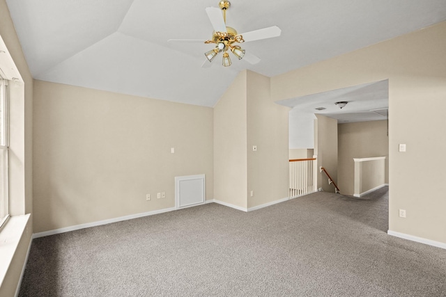 carpeted spare room with ceiling fan and lofted ceiling