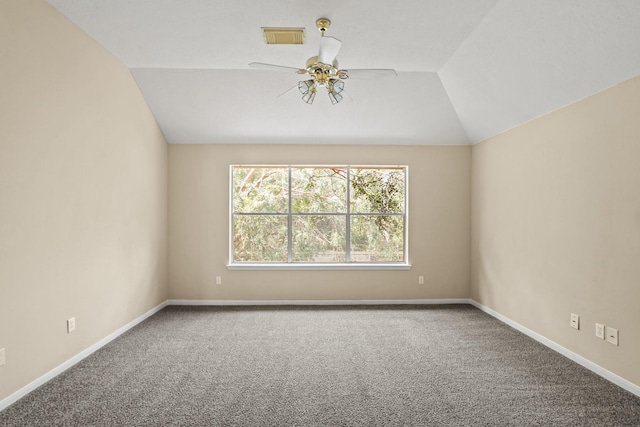 unfurnished room featuring carpet, vaulted ceiling, and ceiling fan