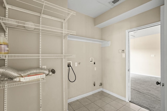 clothes washing area with hookup for an electric dryer, gas dryer hookup, light colored carpet, and hookup for a washing machine