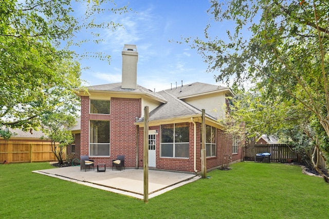 back of property featuring a lawn and a patio