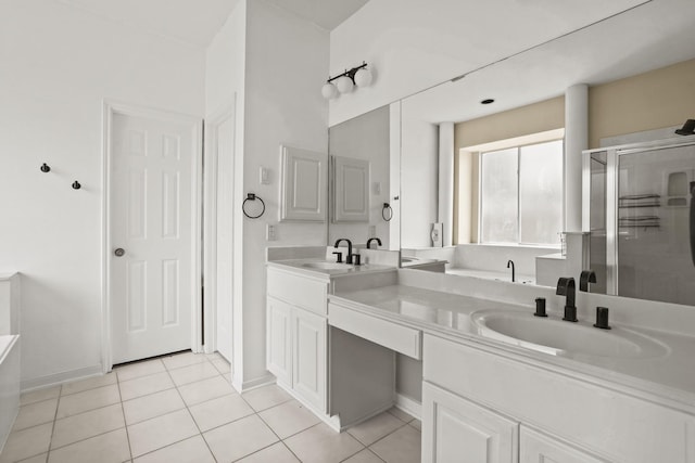 bathroom with tile patterned flooring, vanity, and a shower with door