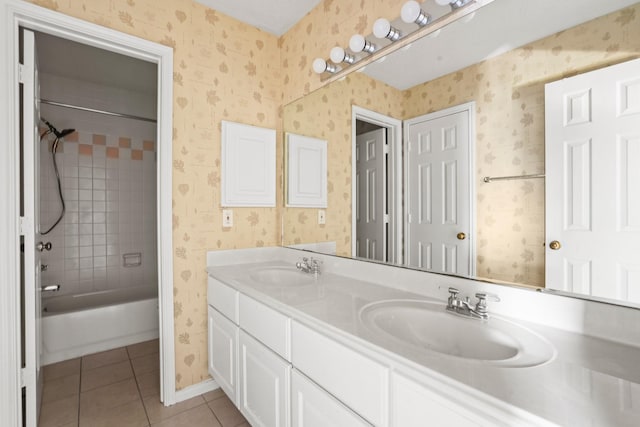 bathroom with tile patterned floors, vanity, and tiled shower / bath combo