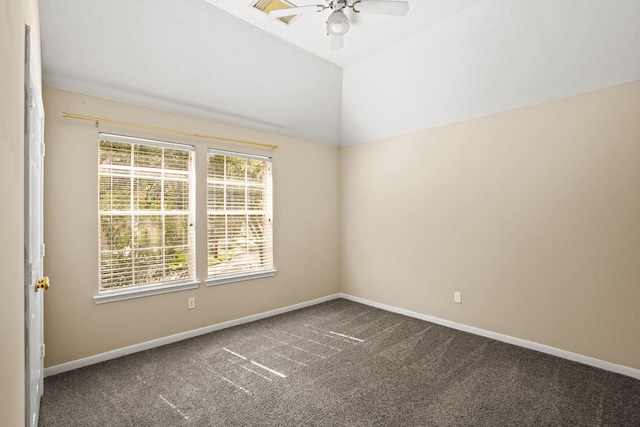 carpeted empty room with ceiling fan and vaulted ceiling