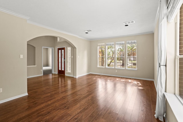 unfurnished room with ornamental molding and dark wood-type flooring