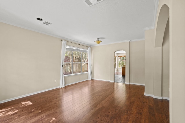 empty room with dark hardwood / wood-style floors and ornamental molding