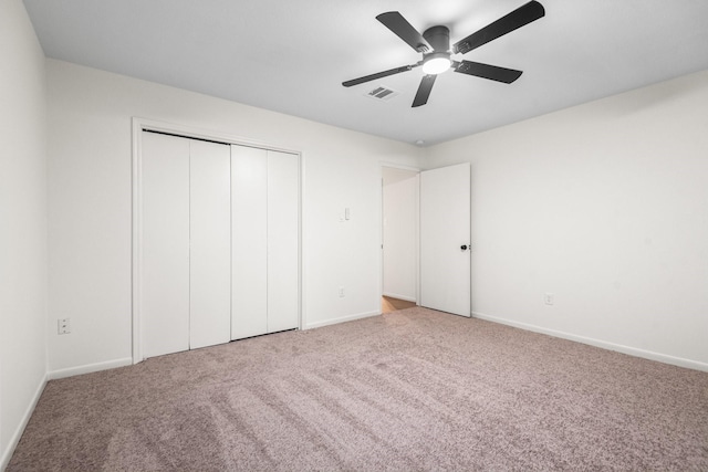 unfurnished bedroom featuring carpet flooring, a closet, and ceiling fan