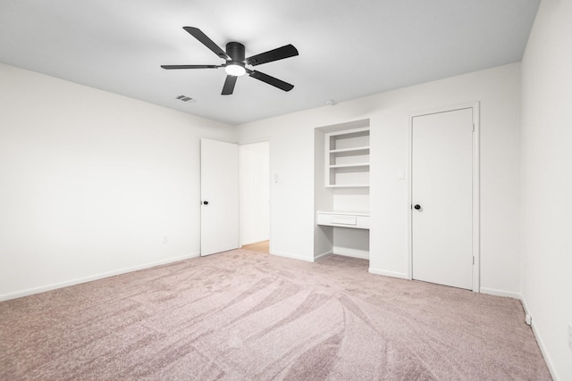 unfurnished bedroom featuring ceiling fan and light carpet