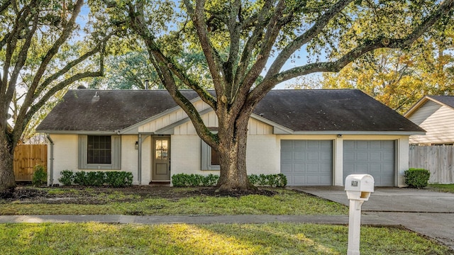 ranch-style house featuring a garage and a front yard