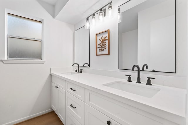 bathroom with hardwood / wood-style flooring and vanity