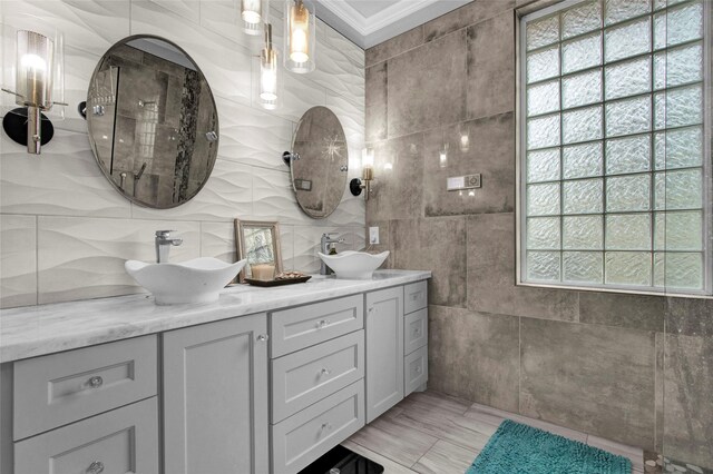 bathroom with vanity, tile walls, and ornamental molding