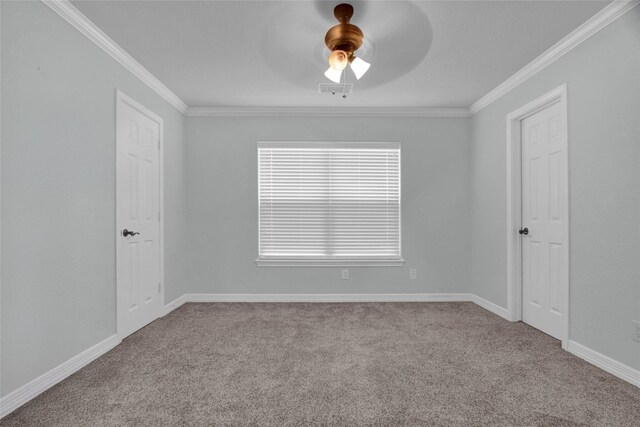 carpeted spare room with ceiling fan and crown molding