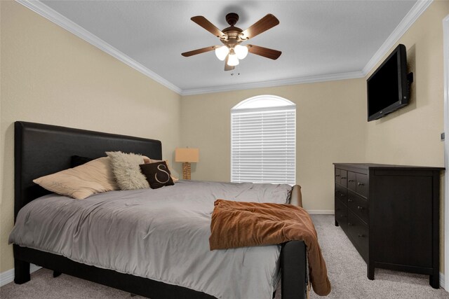 carpeted bedroom featuring ceiling fan and crown molding