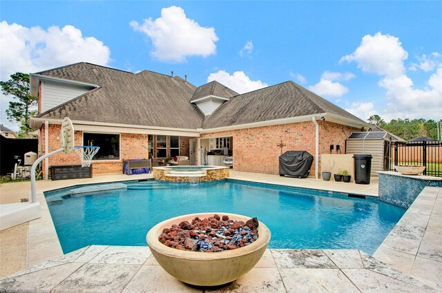 view of pool with an in ground hot tub and area for grilling