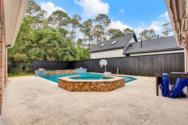 view of pool with an in ground hot tub and a patio