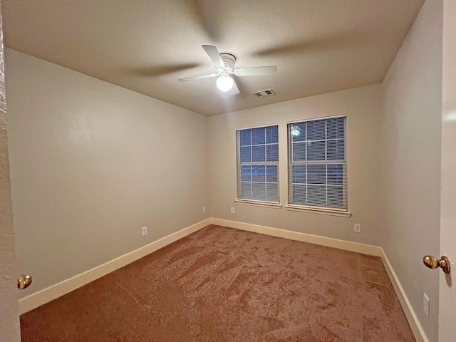 spare room featuring ceiling fan and carpet floors