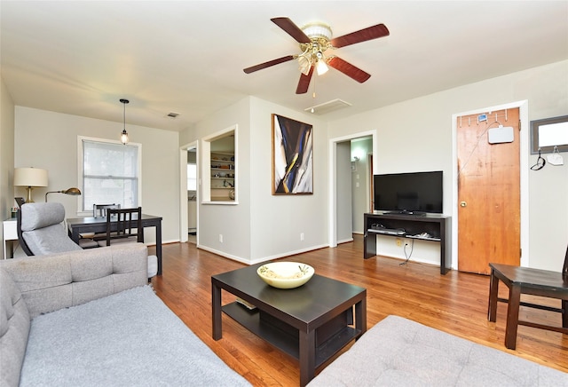 living room featuring ceiling fan and hardwood / wood-style floors