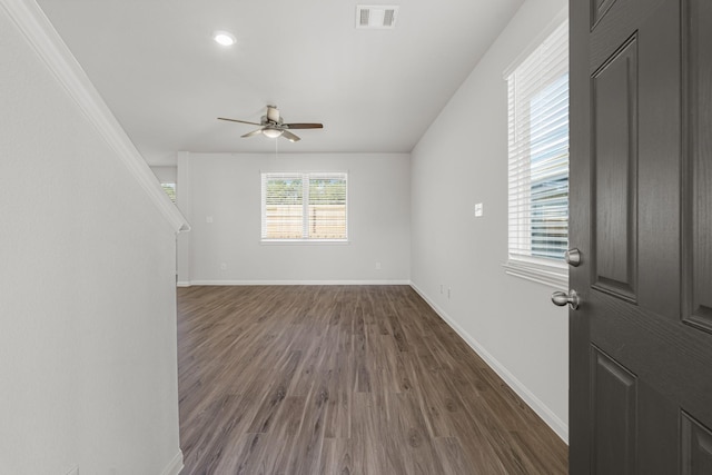 unfurnished living room featuring ceiling fan and dark hardwood / wood-style flooring