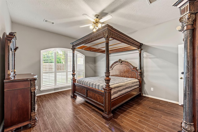 bedroom featuring a textured ceiling, ceiling fan, and dark wood-type flooring