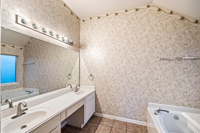 bathroom with tile patterned floors, vanity, lofted ceiling, and a bath