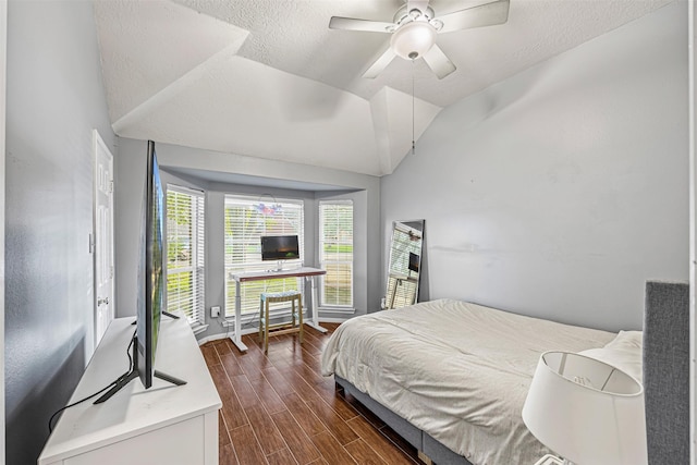 bedroom with a textured ceiling, dark hardwood / wood-style flooring, ceiling fan, and lofted ceiling