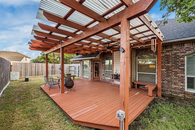 wooden terrace with a yard, a pergola, and cooling unit