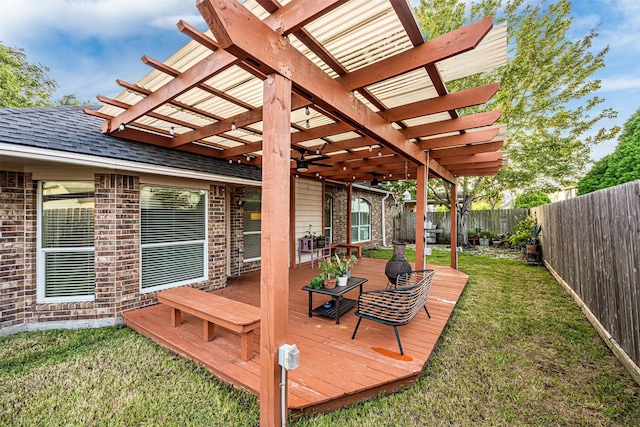 wooden terrace featuring a pergola and a lawn