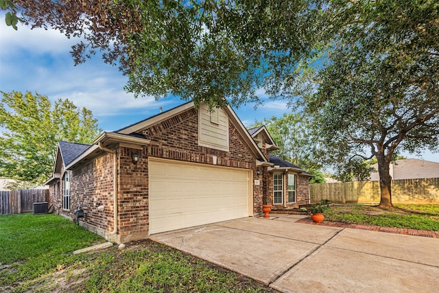 view of front facade featuring central AC, a front yard, and a garage