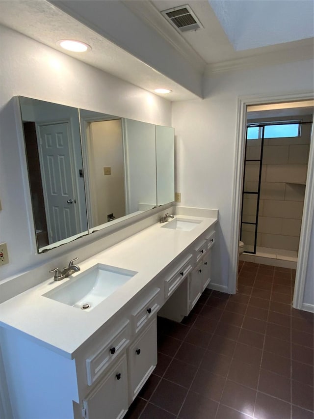 bathroom with tile patterned floors, walk in shower, vanity, crown molding, and toilet