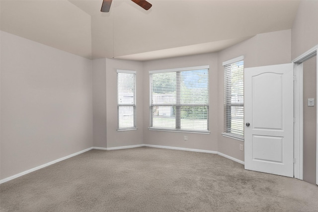 carpeted spare room featuring ceiling fan