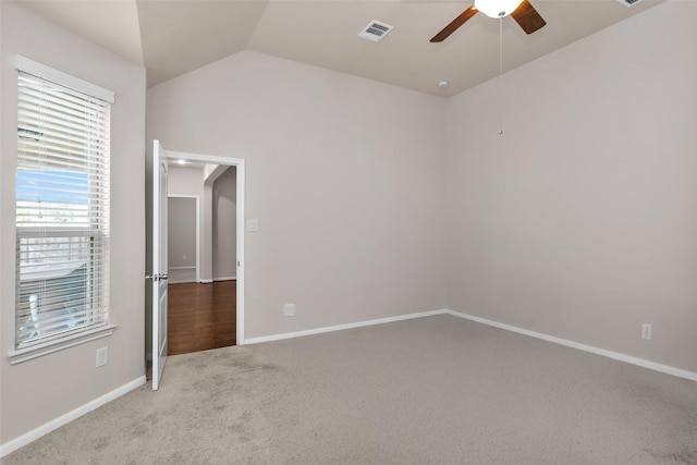 unfurnished bedroom with ceiling fan, light carpet, and vaulted ceiling