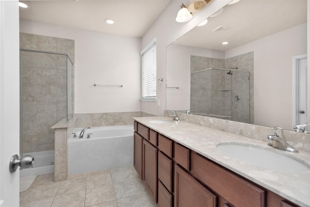 bathroom featuring tile patterned floors, vanity, and shower with separate bathtub