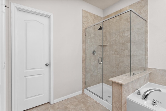 bathroom with separate shower and tub and tile patterned floors