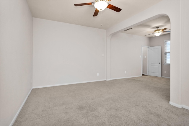 carpeted spare room with ceiling fan