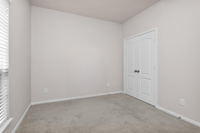 empty room featuring light carpet