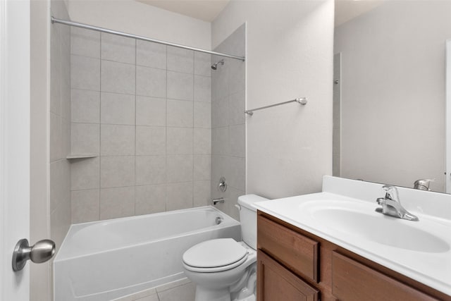 full bathroom featuring tile patterned floors, vanity, toilet, and tiled shower / bath combo