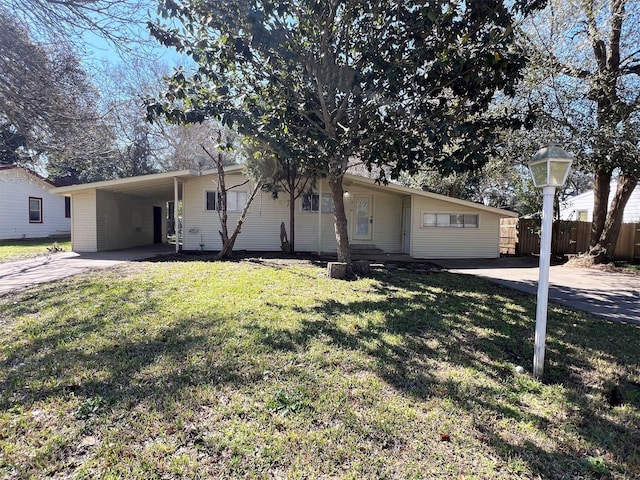 ranch-style house with a front lawn and a carport