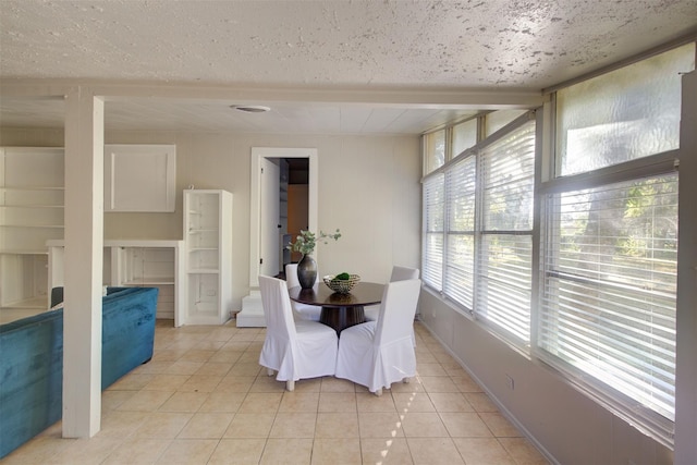 dining area with light tile patterned floors and a textured ceiling