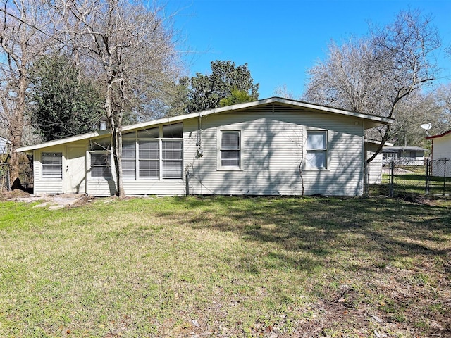 rear view of house featuring a yard