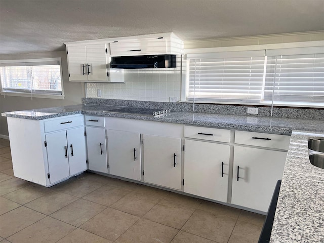 kitchen with white cabinets, light tile patterned floors, ventilation hood, and gas stovetop