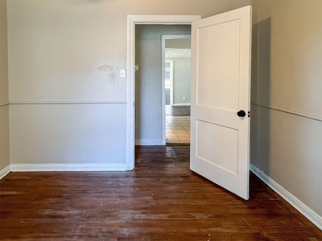 unfurnished room featuring dark wood-type flooring