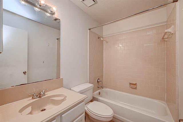 bathroom with visible vents, toilet, vanity, and shower / tub combination