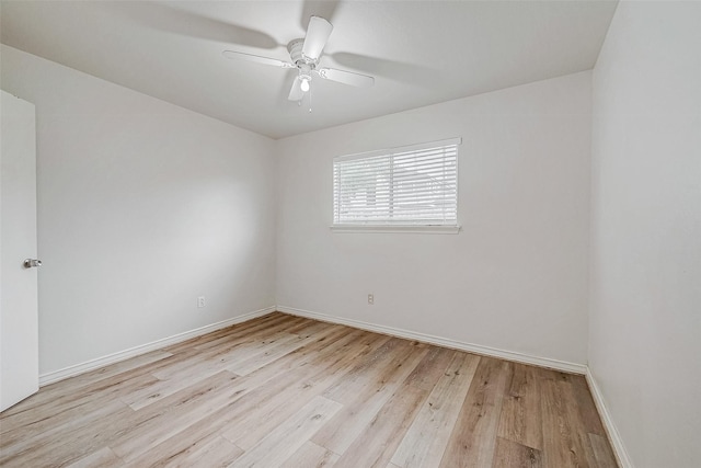 empty room with a ceiling fan, light wood-type flooring, and baseboards