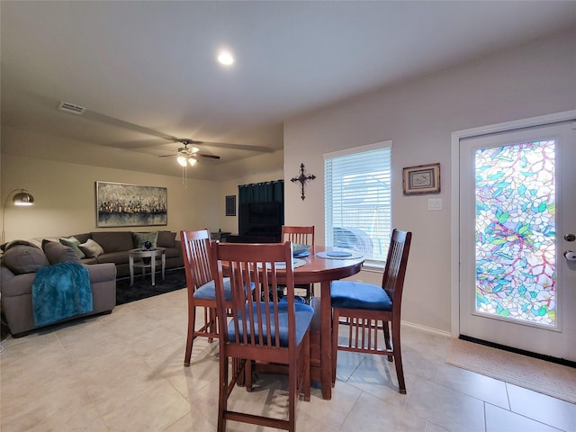 dining space featuring ceiling fan and light tile patterned floors