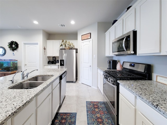 kitchen with white cabinets, stainless steel appliances, and sink