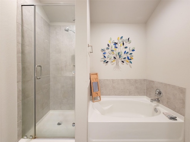 bathroom featuring shower with separate bathtub