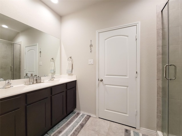 bathroom with tile patterned flooring, vanity, and a shower with shower door