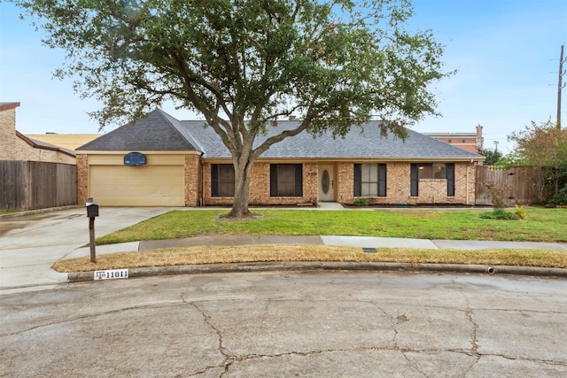 ranch-style home with a front yard and a garage