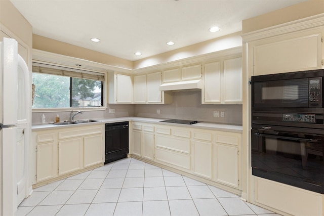 kitchen featuring light tile patterned floors, sink, cream cabinets, and black appliances